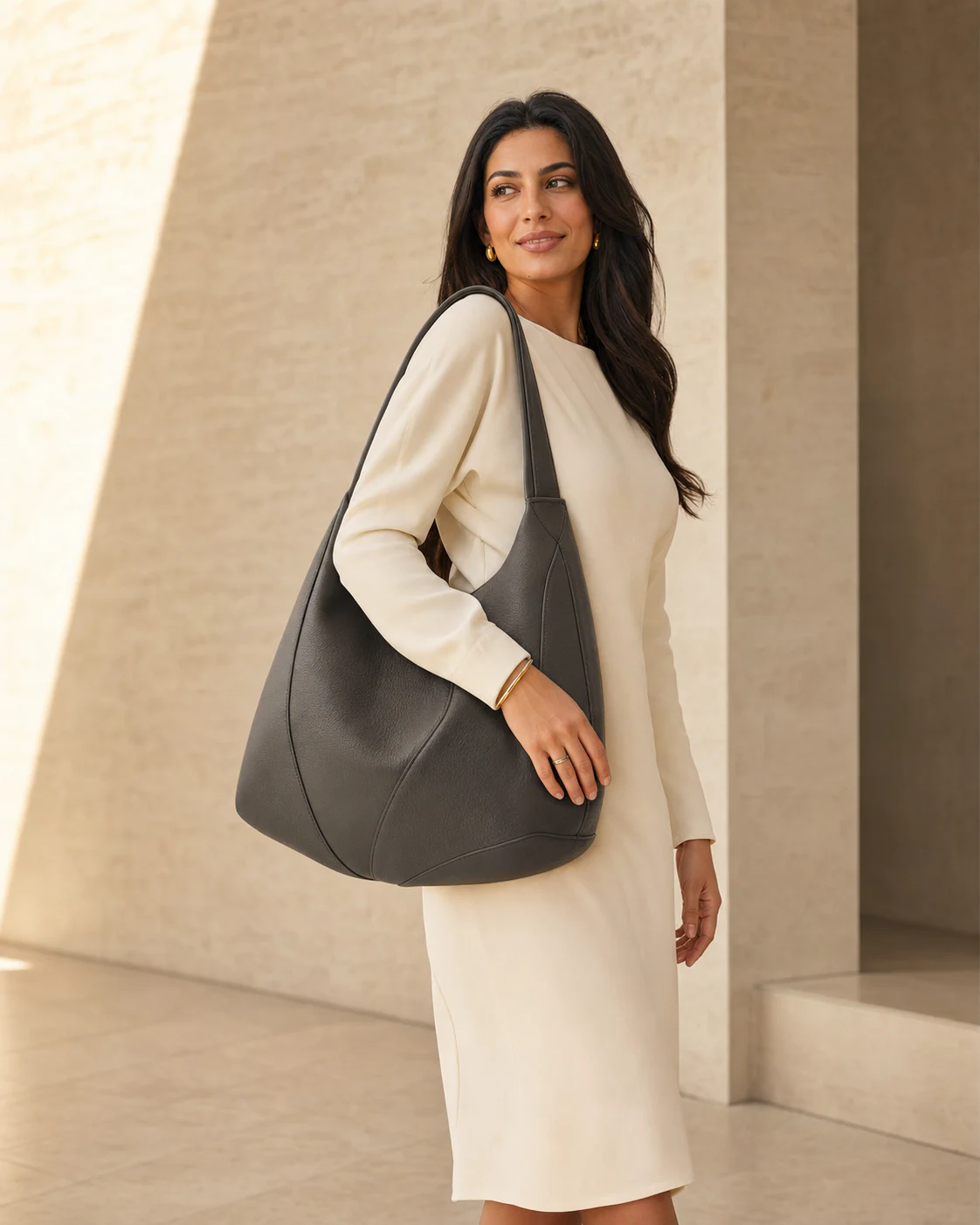 A shopper carrying a charcoal shoulder bag