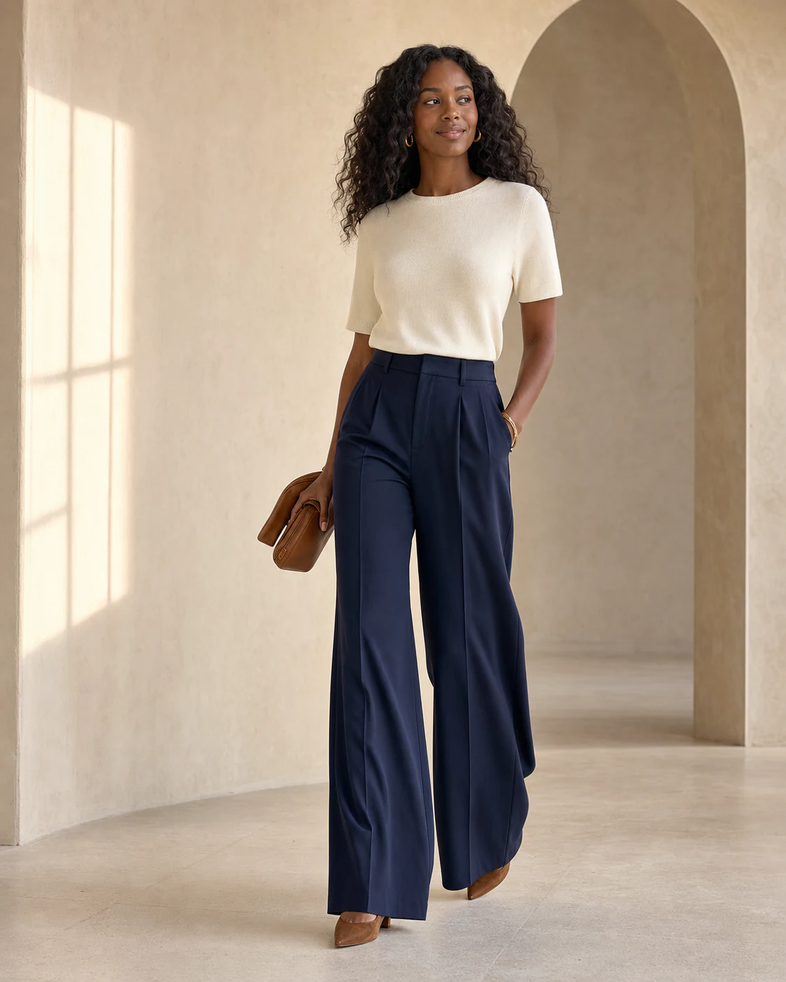 A shopper wearing navy wide-leg trousers