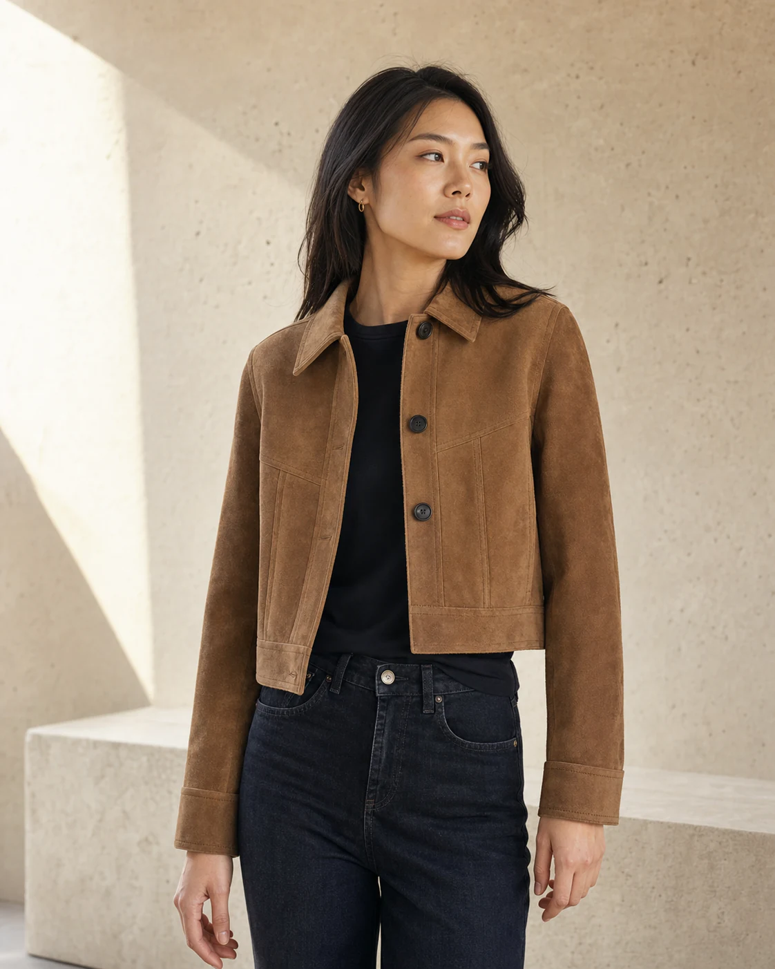 A shopper wearing a camel suede jacket