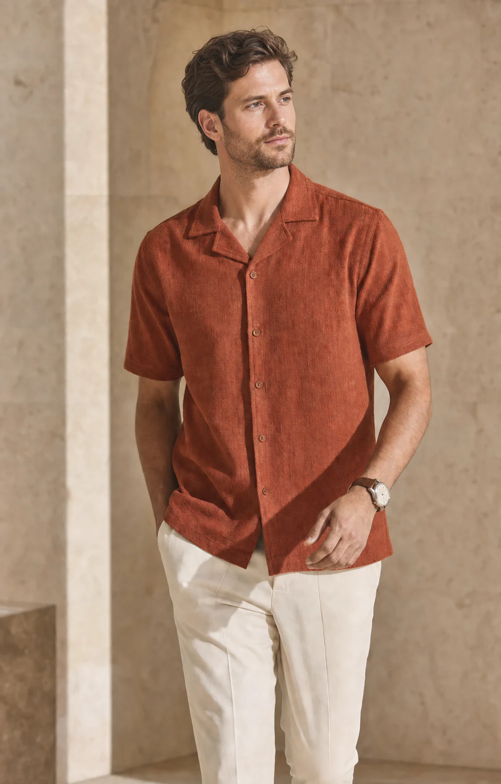 A shopper wearing a rust camp-collar shirt